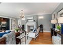 Inviting living room showcasing a fireplace, chandelier lighting, and ample natural light through French doors at 567 E Wesley Ne Rd, Atlanta, GA 30305