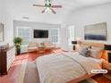 Spacious main bedroom with vaulted ceilings, two windows and hardwood floors at 1869 Appaloosa Mill Ct, Buford, GA 30519