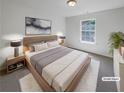 Comfortable bedroom with a plush bed, soft carpet, and a bright window for natural light at 3677 Utoy Sw Dr, Atlanta, GA 30331