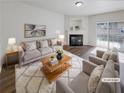 Cozy living room with a fireplace, plush seating, and sliding glass doors to the outside at 3677 Utoy Sw Dr, Atlanta, GA 30331