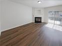 Bright living room with wood floors, a fireplace, and sliding glass doors that allow for abundant natural light at 3677 Utoy Sw Dr, Atlanta, GA 30331