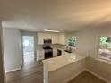 Bright kitchen featuring white cabinets, stainless steel appliances, quartz countertops, and durable vinyl floors at 3825 Emerson St, Marietta, GA 30062