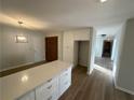 Open-concept kitchen boasts a large center island with quartz countertops, ample cabinet space, and vinyl flooring at 3825 Emerson St, Marietta, GA 30062