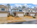 Inviting two-story home with brick accents, a two-car garage, and neat landscaping, creating curb appeal at 5915 Pinnacle View Rd, Cumming, GA 30040