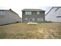 View of a large, unfinished backyard with some grass and a small patio at 2551 Bear Mountain St, Lithonia, GA 30058