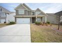 Charming two-story home with a two-car garage, covered porch, and manicured lawn at 2551 Bear Mountain St, Lithonia, GA 30058