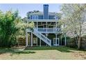 Two-story home featuring a walk-out basement and back patio with steps leading to a spacious yard at 3268 Cates Ne Ave, Brookhaven, GA 30319