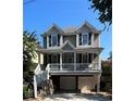 Two-story home featuring a welcoming front porch, neutral siding, craftsman-style details, and a garage at 3268 Cates Ne Ave, Brookhaven, GA 30319