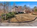 Well-manicured front lawn with an attractive mailbox post leading to a two-story brick home at 3699 Fowler Rdg, Douglasville, GA 30135