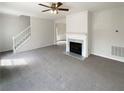 Neutral living room featuring a fireplace, carpet and natural light at 890 Abbotts Mill Ct # 75, Duluth, GA 30097