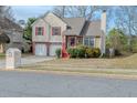 Charming two-story home with a two-car garage and inviting red porch steps at 4096 Mistymorn Ln, Powder Springs, GA 30127
