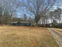 A charming single-story home with a private driveway and a sprawling lawn, perfect for outdoor activities at 9588 Poston Rd, Jonesboro, GA 30238