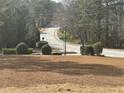 A quaint street intersection with lush greenery and mature trees, offering a serene and picturesque setting at 9588 Poston Rd, Jonesboro, GA 30238