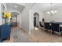 Welcoming foyer with wood flooring, arched doorways, leading to the dining and living areas at 461 Charleston Pl, Villa Rica, GA 30180