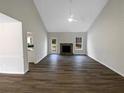 Open living room with vaulted ceiling and stone fireplace, perfect for gathering at 521 Country Lake Dr, Mcdonough, GA 30252