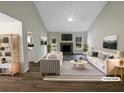 Bright living room featuring a stone fireplace, vaulted ceilings, and modern decor at 521 Country Lake Dr, Mcdonough, GA 30252