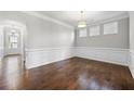 Inviting dining room featuring hardwood floors, wainscoting, and elegant lighting for memorable meals at 667 Creswell Park, Smyrna, GA 30082