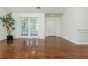 Bright living room with hardwood floors and french doors leading to outdoor space at 2406 Village Ln, Roswell, GA 30075