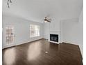 Bright living room features fireplace, ceiling fan, and hardwood floors at 212 Riverstone Commons Cir, Canton, GA 30114