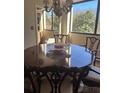 Dining room with traditional dark wood furniture and serene treetop views at 3530 Piedmont Ne Rd # 3I, Atlanta, GA 30305