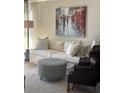 Comfortable living room with an abstract painting above a neutral sofa at 3530 Piedmont Ne Rd # I3, Atlanta, GA 30305