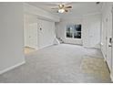 Bright living room with plush carpet, neutral tones, and ample natural light at 483 Fairlane Nw Cir, Atlanta, GA 30331