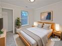 Cozy main bedroom featuring a comfortable bed, natural lighting, and neutral decor at 483 Fairlane Nw Cir, Atlanta, GA 30331