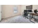 Well-lit office with neutral carpet, a window, and a modern desk setup at 4929 Dufour Dr, Lilburn, GA 30047