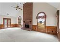 Bright living room with a brick fireplace, large windows, wood trim, and access to the outdoors at 10625 Haynes Forest Dr, Alpharetta, GA 30022