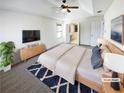Large main bedroom featuring a ceiling fan, tv, and ensuite bathroom at 2208 Howell Farms Nw Pt, Acworth, GA 30101