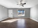 Bright, open living room featuring hardwood floors and a white door at 338 Thorn Thicket Dr, Rockmart, GA 30153