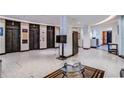 Bright, spacious lobby with tiled floors, marble columns, and elevator access at 20 Marietta Nw St # 15D, Atlanta, GA 30303