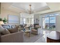 Bright and airy living room features a modern chandelier and balcony access at 325 E Paces Ferry Ne Rd # 2005, Atlanta, GA 30305