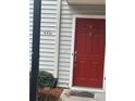 Condo entrance with bright red door with gray siding and manicured bushes at 4351 Timberlake, Stone Mountain, GA 30083