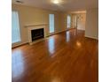 Open living room with fireplace, hardwood floors, and plenty of natural light through large windows at 4351 Timberlake, Stone Mountain, GA 30083