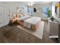 Bright and spacious main bedroom featuring neutral carpet, ceiling fan, and large windows for plenty of natural light at 5025 Skipping Stone Ct, Cumming, GA 30028