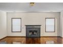 Living room featuring a fireplace and two windows at 5589 Dendy Trace, Fairburn, GA 30213