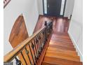 Staircase with wooden steps and decorative iron railings leading to the hardwood floor entrance at 5589 Dendy Trace, Fairburn, GA 30213