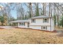 Attractive split-level home with a covered carport and manicured front yard at 8483 Magnolia Dr, Jonesboro, GA 30238