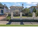 Beautiful home with manicured landscaping, brick driveway, and black wrought iron fence at 115 17Th Ne St, Atlanta, GA 30309