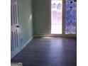 Bright room featuring wood-look flooring, fresh paint, and a large door to a covered patio at 6258 Mount Zion Blvd, Morrow, GA 30260
