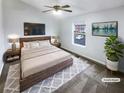 Cozy bedroom features a ceiling fan, a comfortable bed, and natural light from the window at 6420 Wedgeview Dr, Tucker, GA 30084