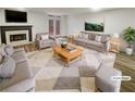 Bright living room featuring modern furniture, a fireplace, and access to an outdoor area at 6420 Wedgeview Dr, Tucker, GA 30084