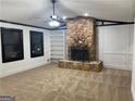 Spacious living room featuring a striking stone fireplace and custom built-in shelving at 7280 Oswego Trl, Riverdale, GA 30296