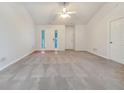 Open living room with neutral walls, plush carpeting and bright light at 781 Courthouse Park Dr, Temple, GA 30179