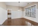 Bright dining room featuring hardwood floors, wainscoting, and a large window for natural light at 3137 Primrose St, Douglasville, GA 30135