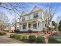 Two-story home with inviting front porch, complemented by lush landscaping and mature trees at 3137 Primrose St, Douglasville, GA 30135