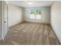 Neutral bedroom featuring carpet, a window, and a closet at 3308 Steeple Chase Sw Way, Conyers, GA 30094