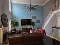 Comfortable living room with a fireplace, hardwood floors, and a staircase leading to the second floor at 3578 Willow Spring Ct, Decatur, GA 30034