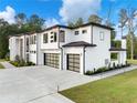 Contemporary home showcasing clean lines, modern garage doors, and a well-maintained yard at 2940 Old Peachtree Rd, Dacula, GA 30019